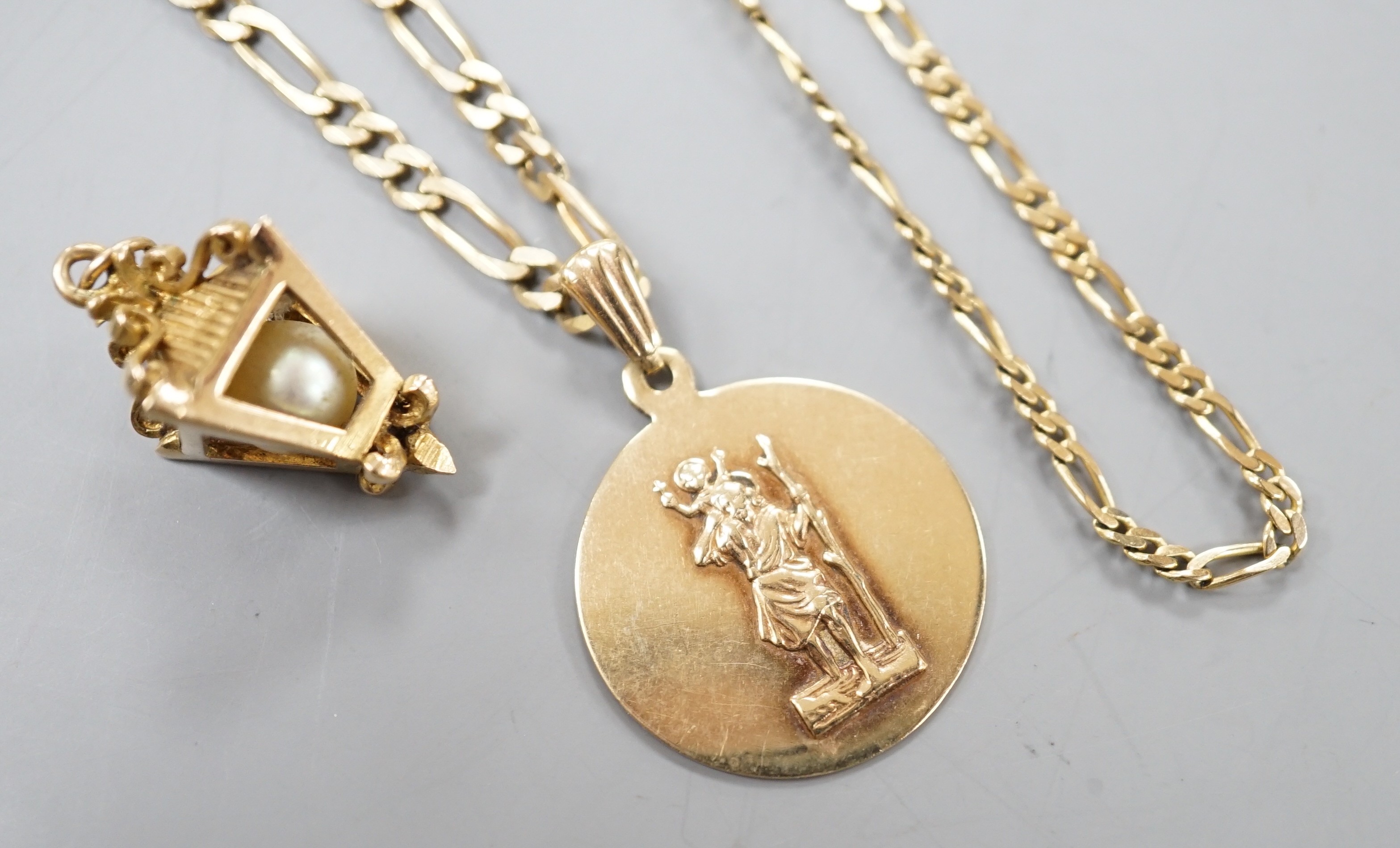 A modern 9ct gold chain with lantern pendant and a 9ct chain with 9ct circular pendant, gross 16.9 grams.